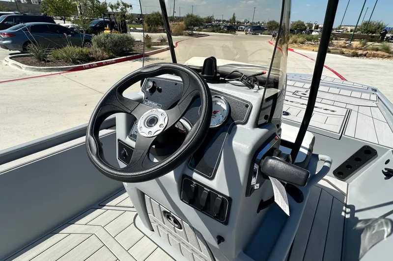 Slide: The Image of 2027 Tracker Bass Tracker Classic CC boat console with steering wheel and controls. - 18