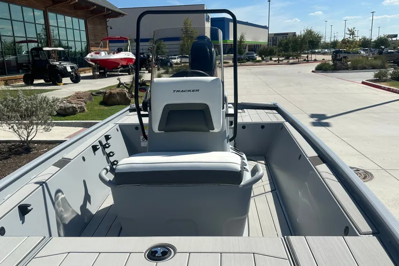 Slide: The Image of 2027 Tracker Bass Tracker Classic CC boat interior at a dealership, showcasing seating and console. - 20