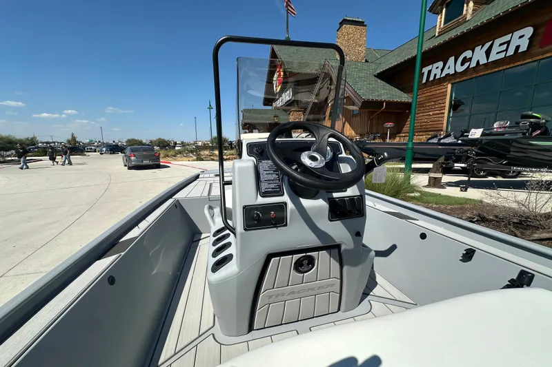Slide: The Image of 2027 Tracker Bass Tracker Classic CC boat interior with steering wheel, displayed outdoors. - 14