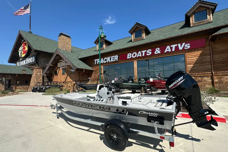 The Image of 2027 Tracker Bass Tracker Classic CC boat displayed outside Tracker Boats & ATVs store. - 1
