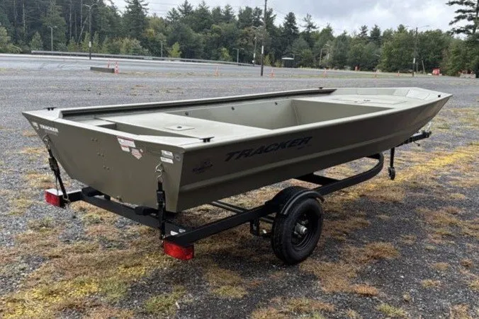 The Image of 2027 Tracker Grizzly 1648 Utility boat on trailer in outdoor setting. - 0