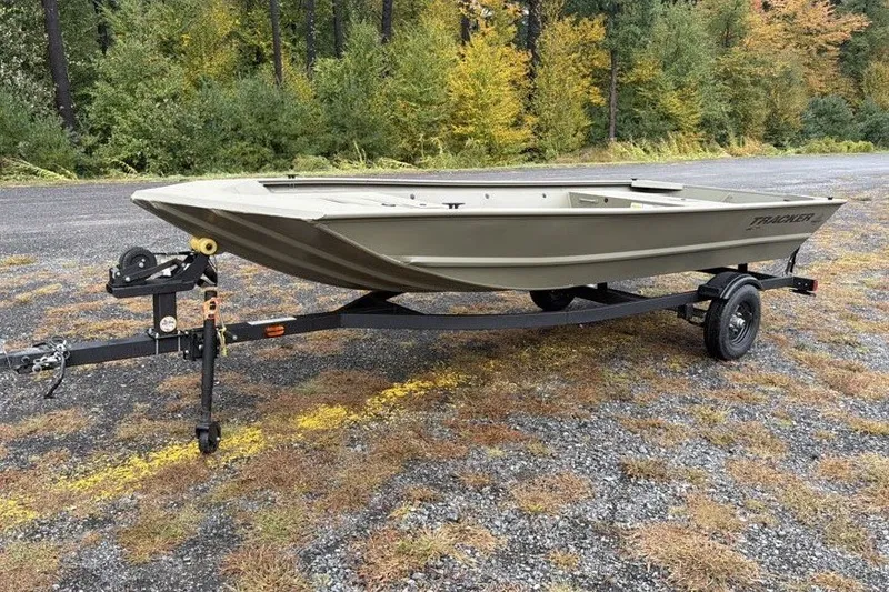 The Image of 2027 Tracker Grizzly 1648 Utility boat on trailer, parked outdoors. - 0
