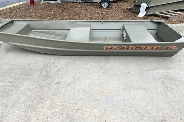 The Image of 2027 Tracker Grizzly 12 Jon boat in a parking lot, showcasing its durable design. - 0