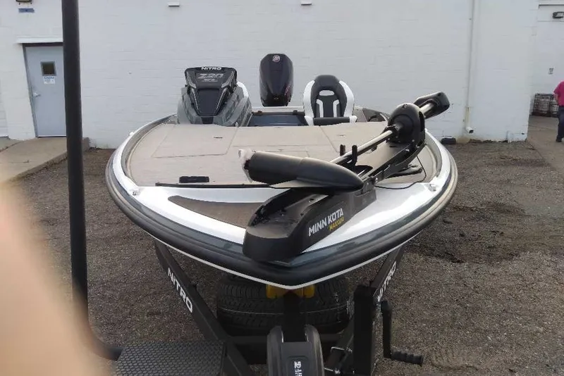 Slide: The Image of 2027 Nitro Z20 XL boat with Minn Kota trolling motor, parked outdoors. - 6