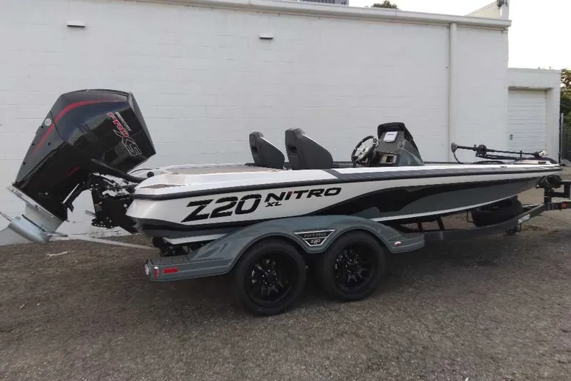 Slide: The Image of 2027 Nitro Z20 XL boat with powerful outboard motor, parked on a trailer. - 2