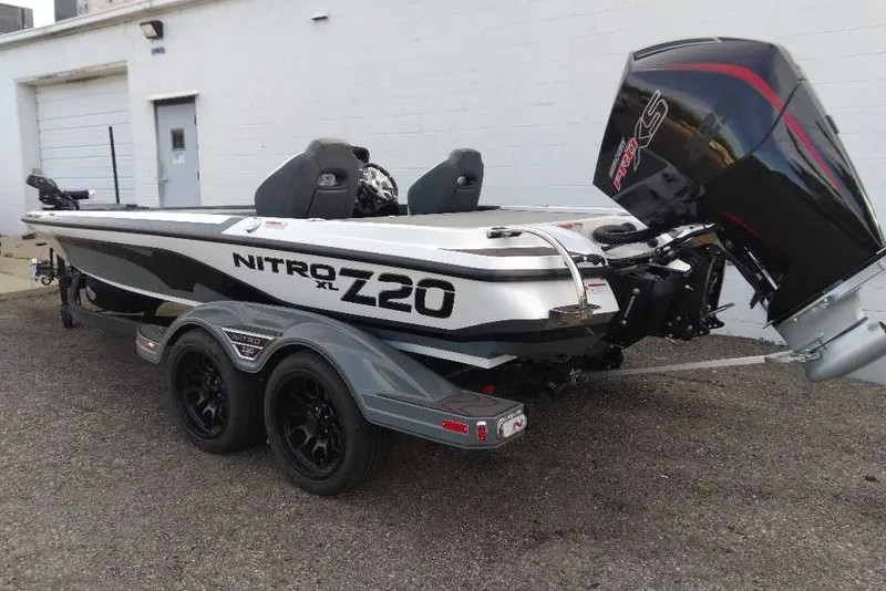 Slide: The Image of 2027 Nitro Z20 XL boat with dual axle trailer, parked outdoors. - 7