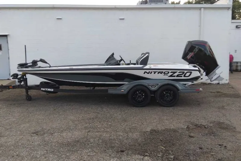 The Image of 2027 Nitro Z20 XL boat on trailer, parked outdoors, side view. - 0