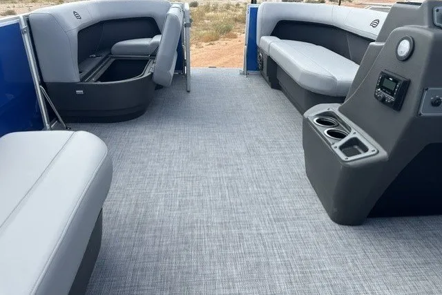Slide: The Image of Interior of 2027 Sun Tracker Party Barge 16 DLX with gray seating and console. - 16