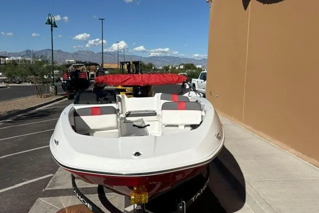 Slide: The Image of 2027 Tahoe T16 boat with red and white seating, parked outdoors on a sunny day. - 4