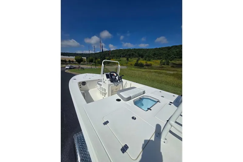 Slide: The Image of 2026 Mako 18 Pro Skiff boat on trailer, scenic outdoor setting. - 6
