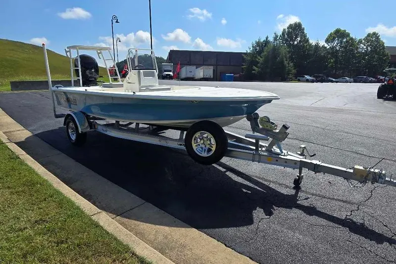 Slide: The Image of 2026 Mako 18 Pro Skiff on trailer in parking lot, sunny day. - 9