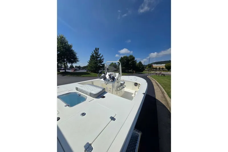 Slide: The Image of 2026 Mako 18 Pro Skiff boat on a sunny day, parked on a paved road. - 3