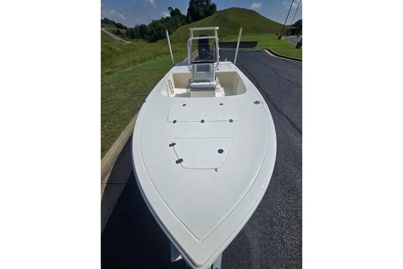 Slide: The Image of 2026 Mako 18 Pro Skiff boat on a sunny day, parked on a paved road. - 7