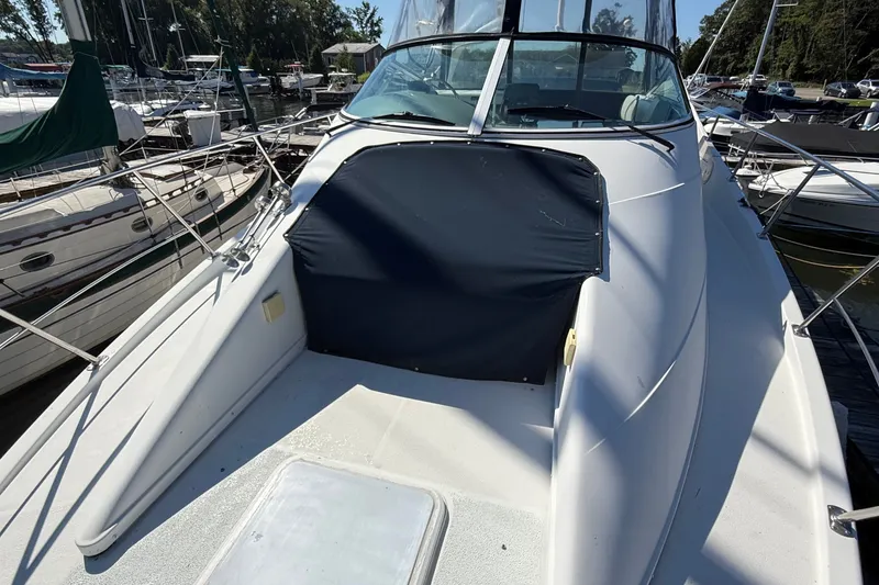 Slide: The Image of 1998 Carver 350 Mariner yacht docked at marina, featuring sleek white deck design. - 7