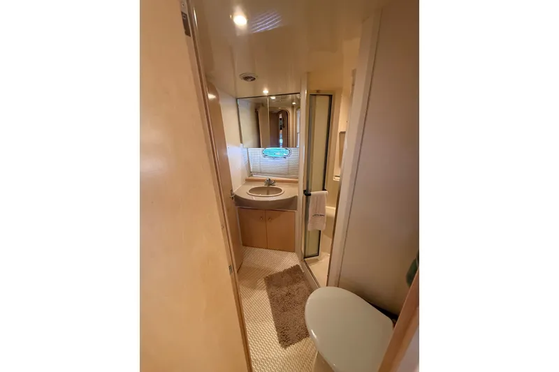 Slide: The Image of 1998 Carver 350 Mariner yacht bathroom with sink, mirror, and shower. - 17