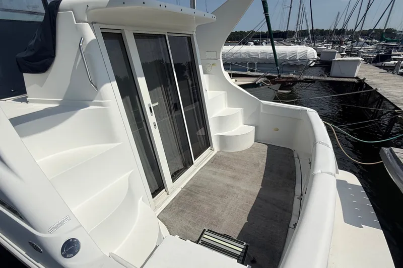Slide: The Image of 1998 Carver 350 Mariner yacht deck with sliding glass doors and marina view. - 4