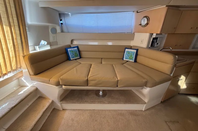 Slide: The Image of Interior of 1998 Carver 350 Mariner yacht with beige seating and nautical decor. - 14