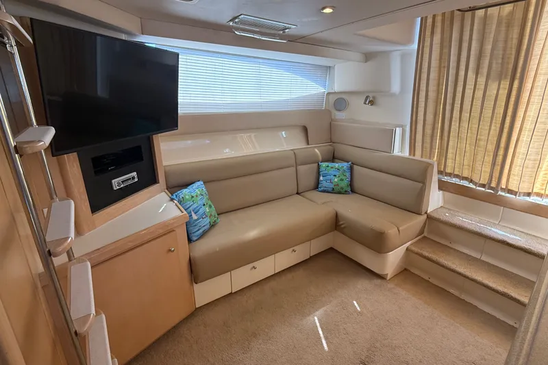Slide: The Image of Interior of 1998 Carver 350 Mariner yacht with beige seating and mounted TV. - 20