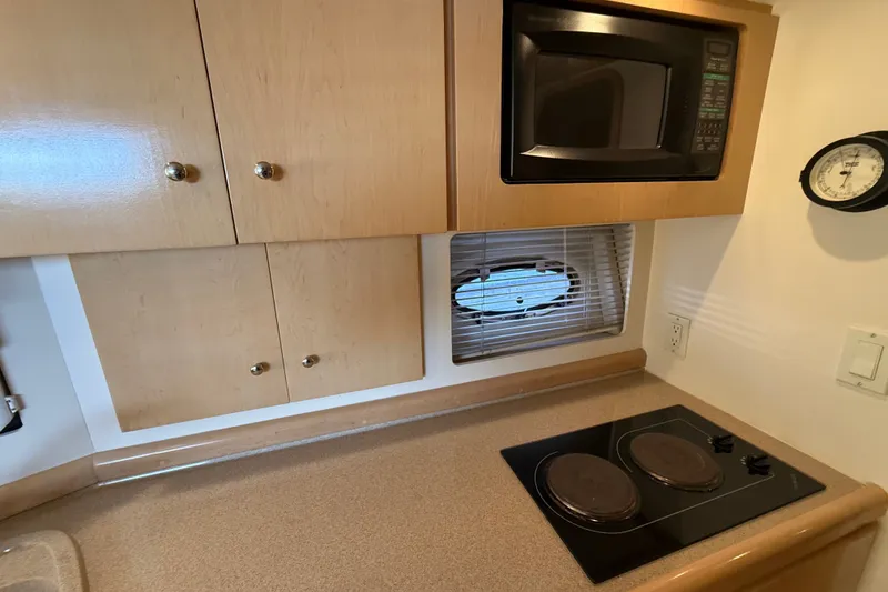 Slide: The Image of Compact kitchen in 1998 Carver 350 Mariner with microwave, stove, and cabinets. - 16