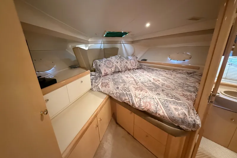 Slide: The Image of Cozy cabin interior of 1998 Carver 350 Mariner yacht with patterned bedding. - 15