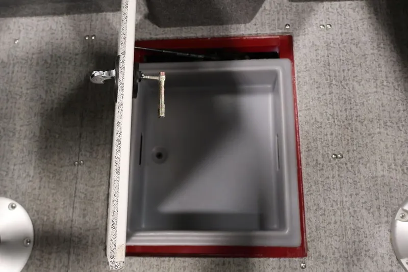 Slide: The Image of Open storage compartment in 2022 Tracker Targa V-19 WT boat, featuring gray interior. - 27