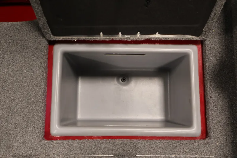Slide: The Image of 2022 Tracker Targa V-19 WT boat storage compartment with gray interior and carpeted edges. - 42