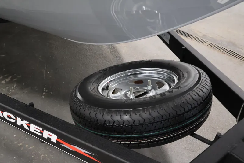 Slide: The Image of 2022 Tracker Targa V-19 WT trailer with spare tire on display. - 56