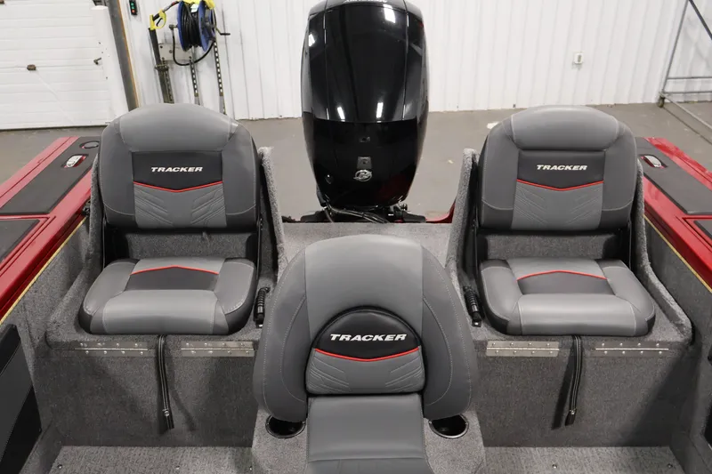 Slide: The Image of 2022 Tracker Targa V-19 WT boat interior with three gray seats and motor. - 46