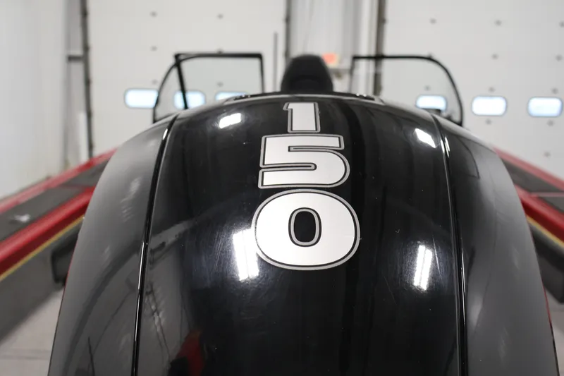 Slide: The Image of 2022 Tracker Targa V-19 WT boat engine with "150" label in a garage setting. - 52