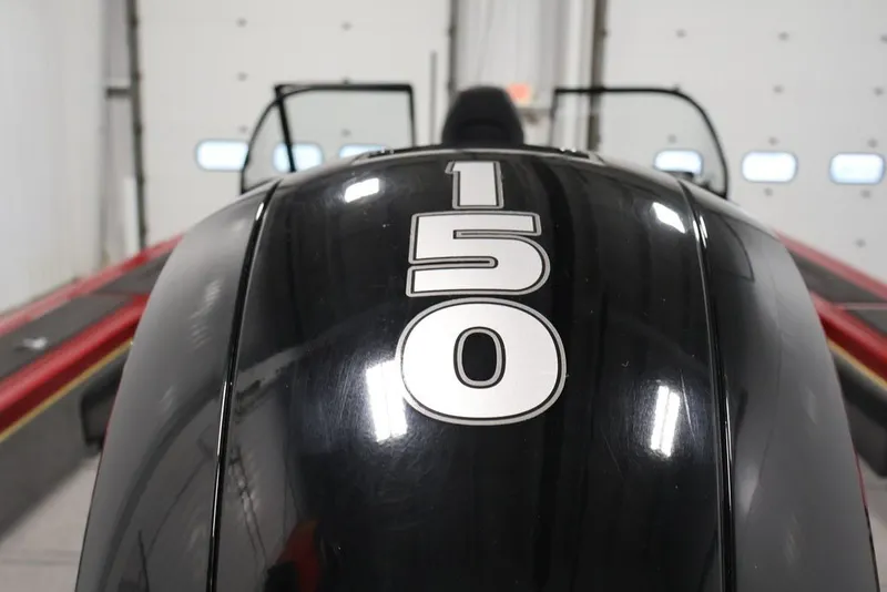 Slide: The Image of 2022 Tracker Targa V-19 WT boat engine with "150" horsepower label in a garage setting. - 45