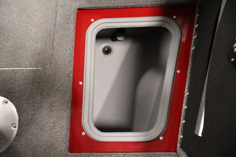 Slide: The Image of Storage compartment in 2022 Tracker Targa V-19 WT boat, featuring red trim and gray interior. - 18