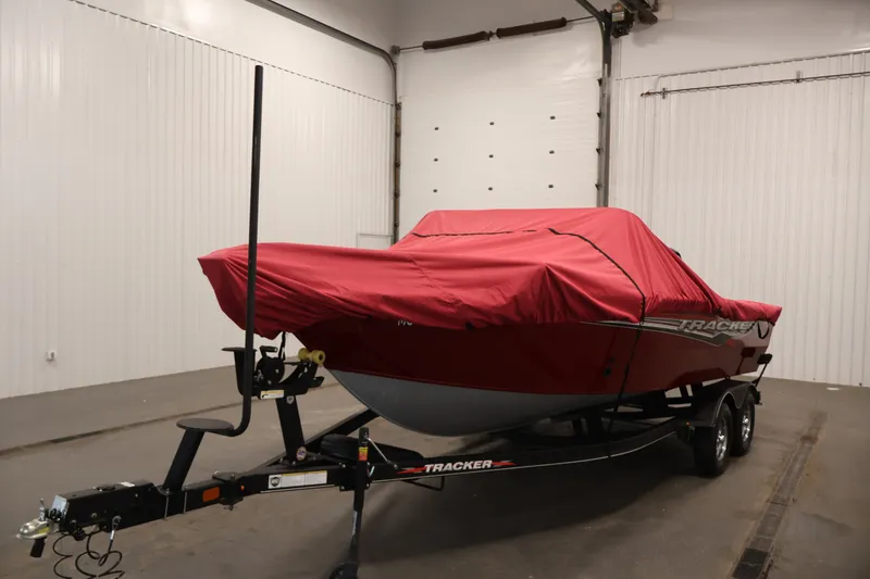 Slide: The Image of 2022 Tracker Targa V-19 WT boat with red cover on trailer in garage. - 59