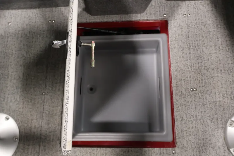 Slide: The Image of Open storage compartment in 2022 Tracker Targa V-19 WT boat, featuring gray interior. - 40