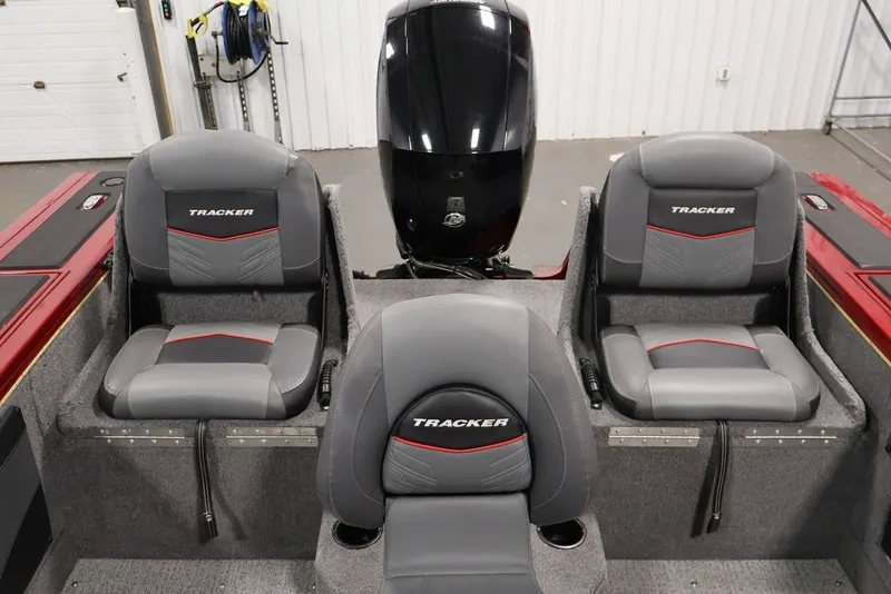 Slide: The Image of 2022 Tracker Targa V-19 WT boat interior with three gray seats and motor. - 54