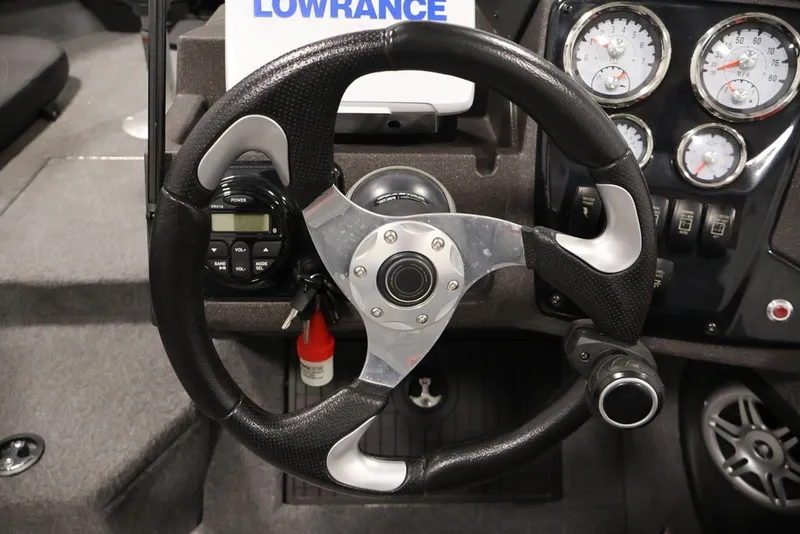 Slide: The Image of Steering wheel and dashboard of 2022 Tracker Targa V-19 WT boat with gauges and controls. - 22