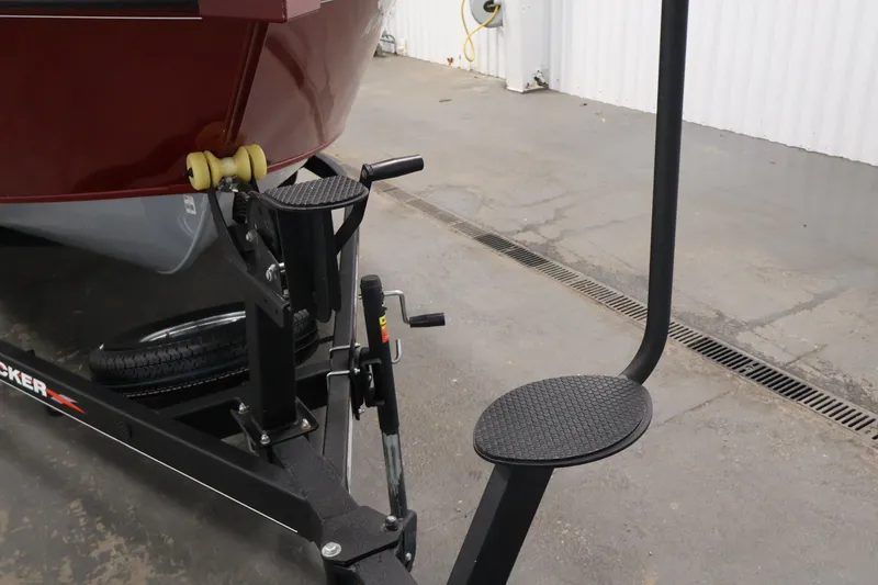 Slide: The Image of 2022 Tracker Targa V-19 WT boat trailer with step and winch in a garage setting. - 55