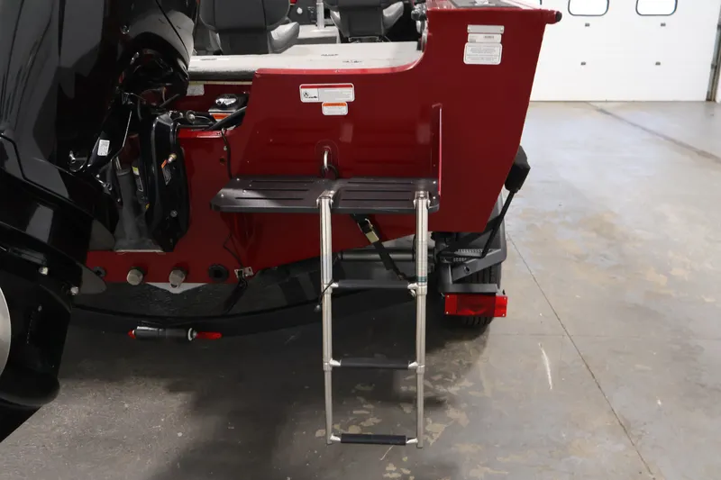 Slide: The Image of 2022 Tracker Targa V-19 WT boat with rear ladder and motor in a garage. - 49