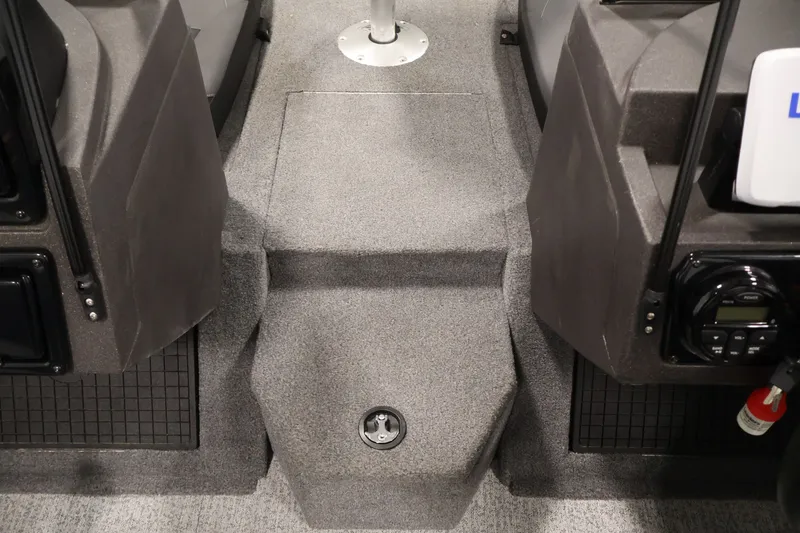 Slide: The Image of Interior view of 2022 Tracker Targa V-19 WT boat, featuring carpeted flooring and console details. - 23
