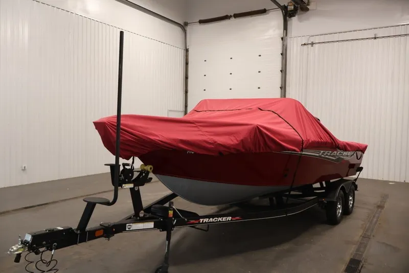 Slide: The Image of 2022 Tracker Targa V-19 WT boat with red cover on trailer in garage. - 62