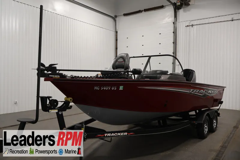 The Image of 2022 Tracker Targa V-19 WT boat in showroom, featuring red exterior and trailer. - 1