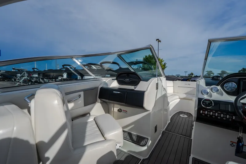 Slide: The Image of Interior of a 2006 Sea Ray 270 SLX boat with white seating and dashboard. - 22