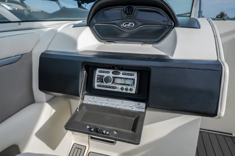 Slide: The Image of 2006 Sea Ray 270 SLX boat dashboard with stereo system and storage compartment. - 38