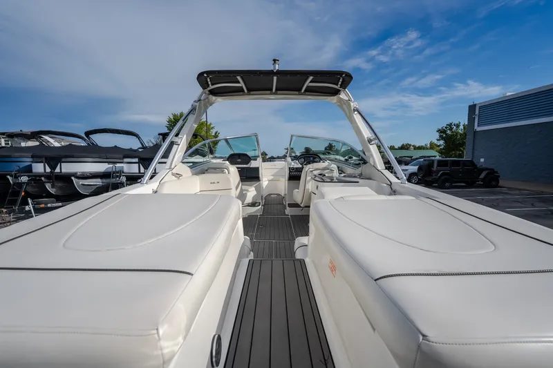 Slide: The Image of 2006 Sea Ray 270 SLX boat interior with white seating and sleek design. - 13