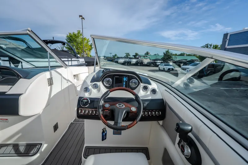 Slide: The Image of Interior view of 2006 Sea Ray 270 SLX boat cockpit with steering wheel and dashboard. - 19