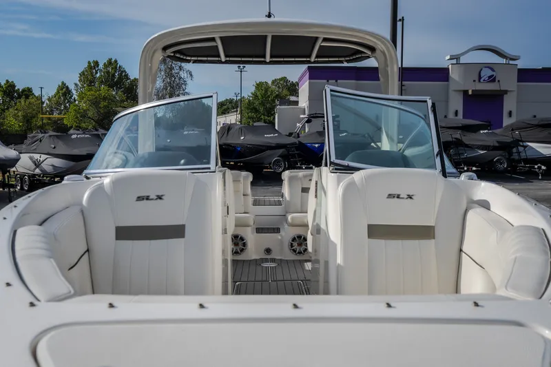 Slide: The Image of 2006 Sea Ray 270 SLX boat interior with white seating and open windshield. - 7