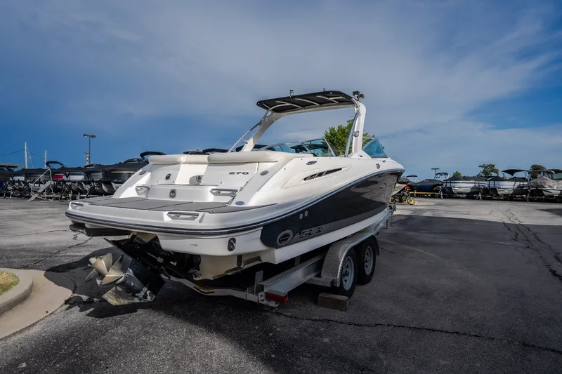 Slide: The Image of 2006 Sea Ray 270 SLX boat on trailer, parked in a marina lot. - 8
