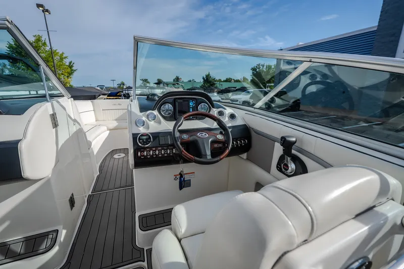 Slide: The Image of 2006 Sea Ray 270 SLX boat interior with steering wheel and dashboard controls. - 18