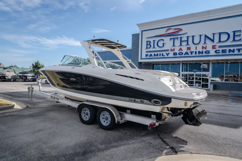 Slide: The Image of 2006 Sea Ray 270 SLX boat on trailer at Big Thunder Marine dealership. - 11