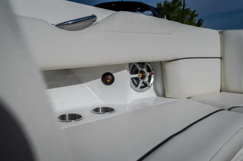 Slide: The Image of Luxurious interior of 2006 Sea Ray 270 SLX boat with white seating and speaker system. - 31