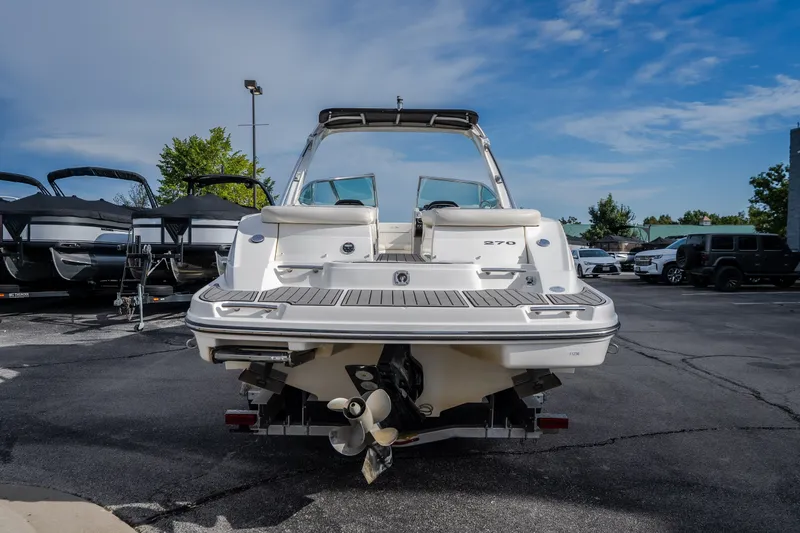 Slide: The Image of 2006 Sea Ray 270 SLX boat, rear view in a parking lot under a clear sky. - 9